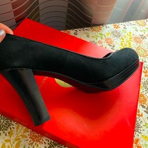 Suede new black platform shoes in a box.